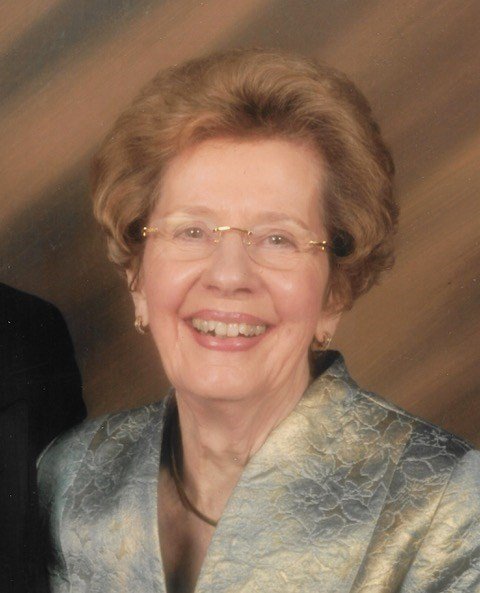 Smiling elderly woman in formal attire