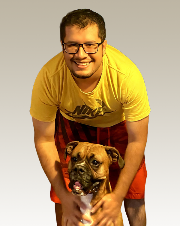 Smiling man with happy brown dog indoors.