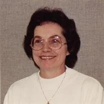 Smiling woman with glasses and dark hair