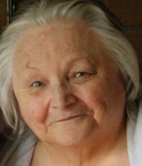 Elderly woman with gray hair smiling warmly.