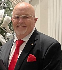 Man in suit with red tie and pocket square