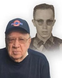 Elderly man with young portrait in background.