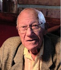 Elderly man wearing a suit and glasses.