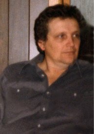 Person sitting indoors looking to the side