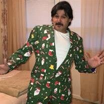 Man wearing festive green Christmas suit indoors.