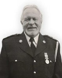 Man in uniform with medals smiling