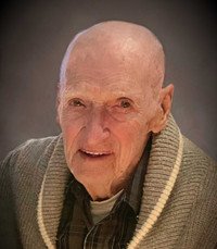 Elderly man smiling in a cozy sweater