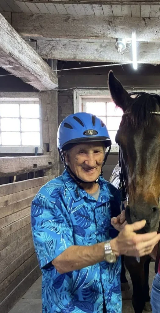TURMELLE, John Paul “Johnny Guy” Turmelle Smiling man wearing helmet with horse