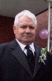 Man in suit standing near balloons
