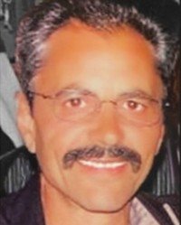 Smiling man with glasses and mustache