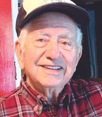 Smiling elderly man in plaid shirt and cap