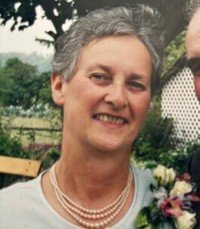 Smiling woman in garden with pearls necklace