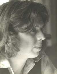 Profile of person with wavy hair, black and white.