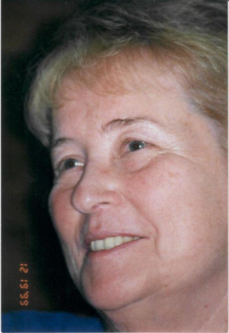 Close-up portrait of an older woman smiling.