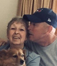 Smiling elderly woman with man and dog