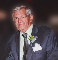 Elderly man in suit with boutonniere.