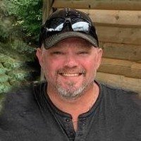 Smiling person wearing a cap outdoors