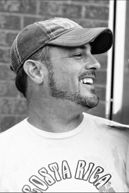 Smiling man in cap and Costa Rica shirt.