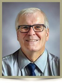 Smiling man wearing glasses and a tie portrait.