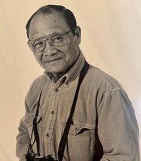 Man in glasses with camera around neck