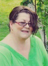 Woman wearing green shirt outdoors