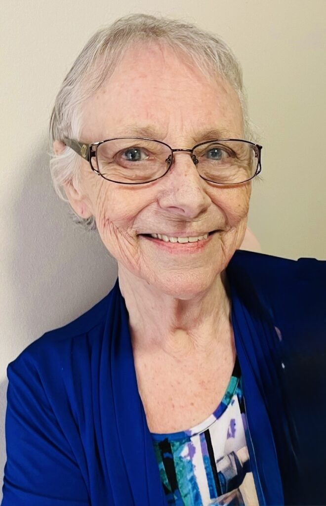 LAROCQUE, Elizabeth "Betty" Hannah Larocque Smiling elderly woman with glasses and blue attire.