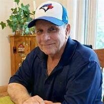 Smiling man wearing Blue Jays cap indoors