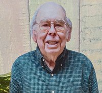 Smiling elderly man in checkered shirt outdoors