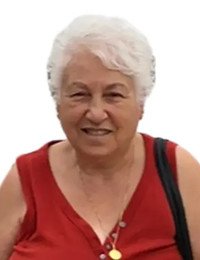 Smiling woman with white hair in red top