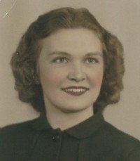 Vintage portrait of smiling woman with curly hair.