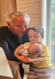 Elderly man and children near window