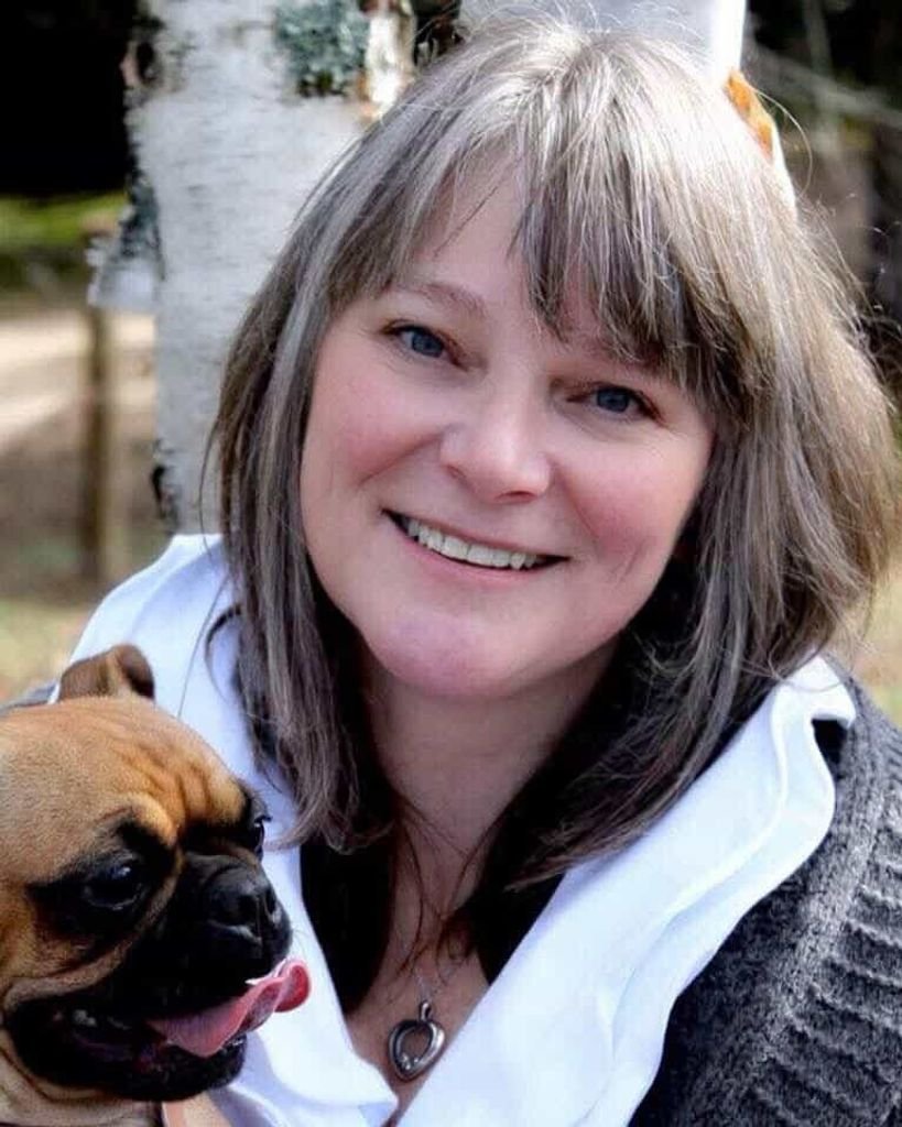 MIDDLEBROOK, Arlene Elizabeth Middlebrook Smiling woman with dog in nature.