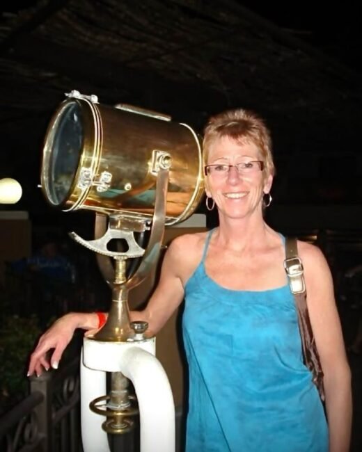 Woman smiling next to a vintage spotlight.