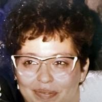 Woman smiling with glasses and short hair