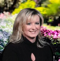 Person smiling in garden setting
