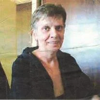 Smiling person in a black shirt indoors