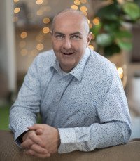 Smiling man indoors with blurred background