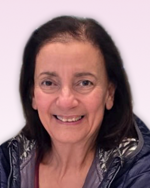 HUSSEY, Loretta "Laurie" Hussey Smiling person in a jacket, light background.