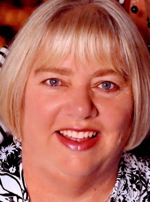 Smiling woman with blonde bob haircut.