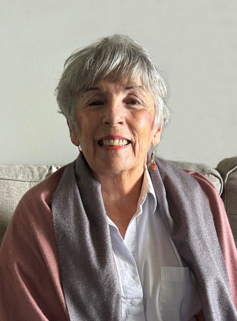 Smiling older woman sitting on a couch