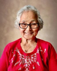 Smiling woman wearing glasses and red sweater