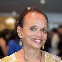 Smiling woman at an indoor gathering
