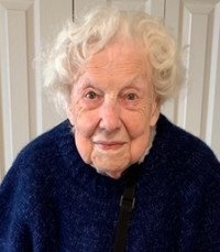 Elderly woman with curly white hair and blue sweater