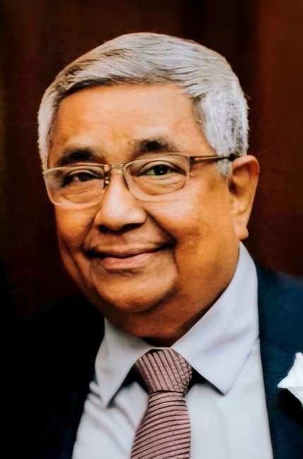 Elderly man smiling in suit and tie
