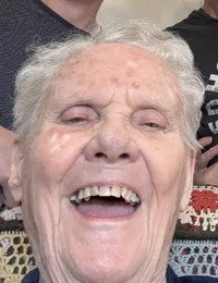 Elderly person smiling joyfully.