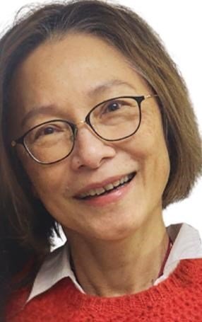 Person smiling with glasses and red sweater
