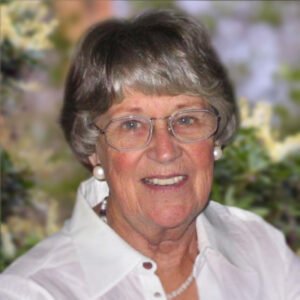 Smiling woman with glasses and gray hair