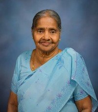 Smiling elderly woman in blue sari
