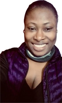 Person smiling, wearing black vest and scarf.