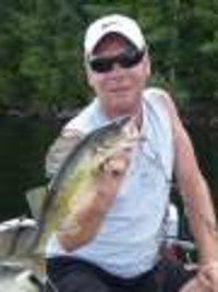 Man holding a fish on a boat